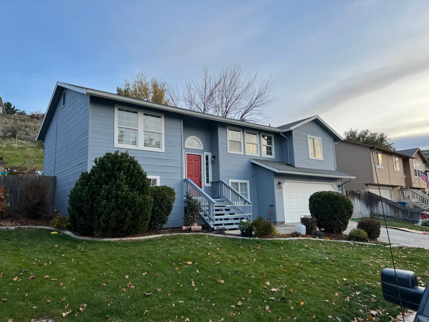Blue two-story house after exterior painting