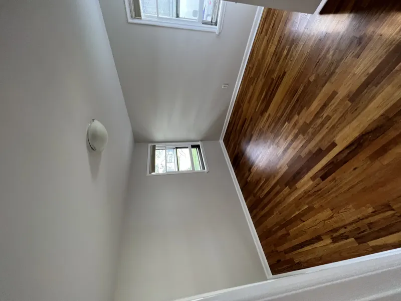 Freshly painted gray room with hardwood floor