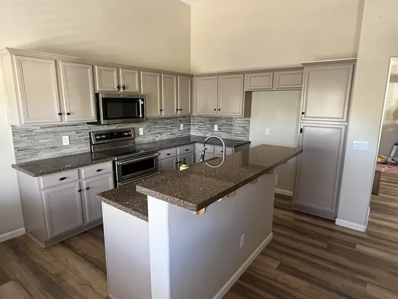 Painted gray kitchen cabinets with island